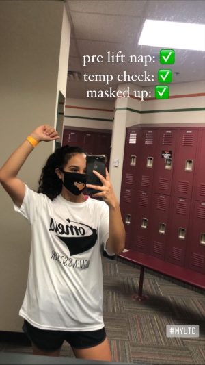 Sofia in a locker room. She's wearing a Comets Womens Soccer t-shirt and Comets mask.