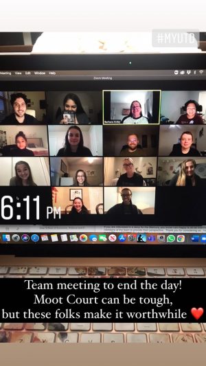 Laptop screen showing a virtual meeting with about a dozen participants. Heart emoji.