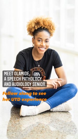 Meet Olamide, a speech pathology and audiology senior. Follow along to see her UTD experience. Pictured, Olamide sits with her legs crossed; she's wearing a black UTD t-shirt, jeans, and white sneakers.