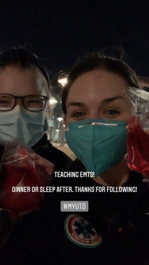Teaching EMTs! Dinner or sleep after. Thanks for following! #myUTD. Pictured, Tess, masked, and another masked person posing together at night.