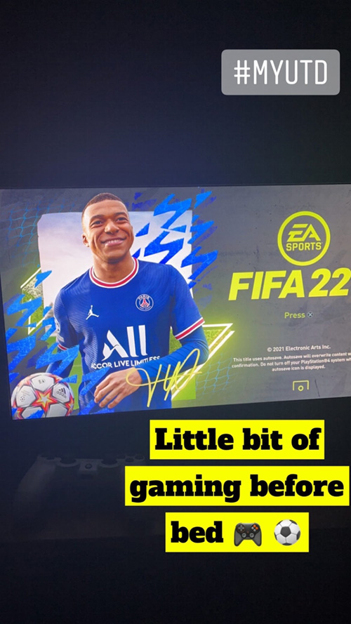 TV screen shows FIFA 22 game. Game controller and soccer ball emoji.