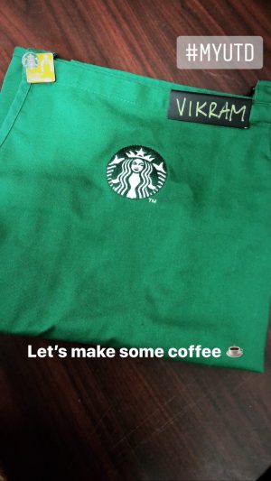 A green apron with a Starbucks logo and name tag that reads, Vikram.