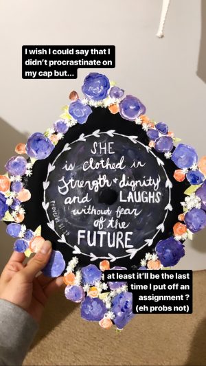 Claudia's graduation cap, which is decorated with purple and orange flowers and reads, She is clothed in strength and dignity and laughs without fear of the future. Proverbs 31:23.