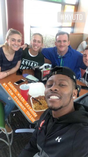 Group selfie of Xavier and four friends at a table in the union.
