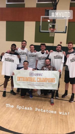 A team of eight people post together. They're holding up or wearing shirts that read, Intramural Champion. Two in front hold a banner that reads UTD UREC Intramural Champions.